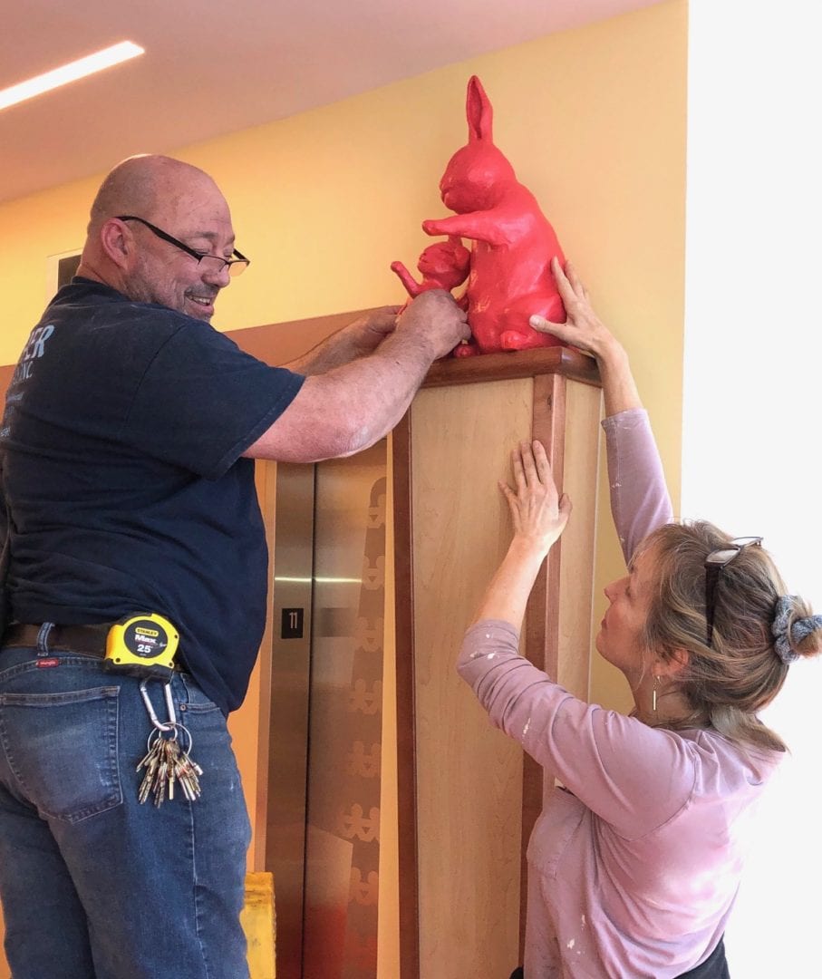 Rachael and Jerry installing the Mama and baby bunny outside the elevator on the 11th floor of Vanderbilt Children's Hospital. © 2020 by artist Rachael 