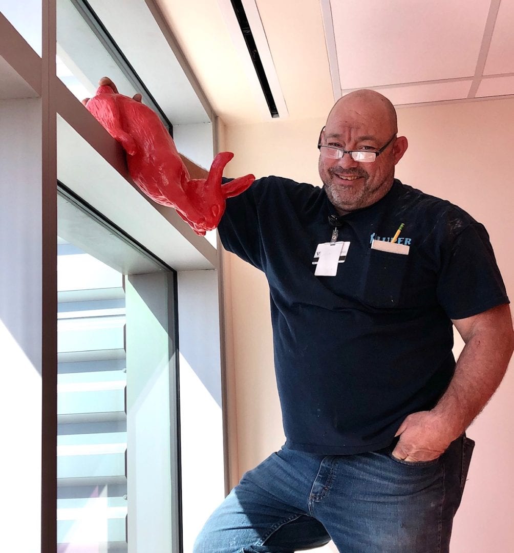 Vanderbilt installer, Jerry, is putting the bunny on the windowsill of the 11th floor installation. © 2020 by Rachael McCampbell