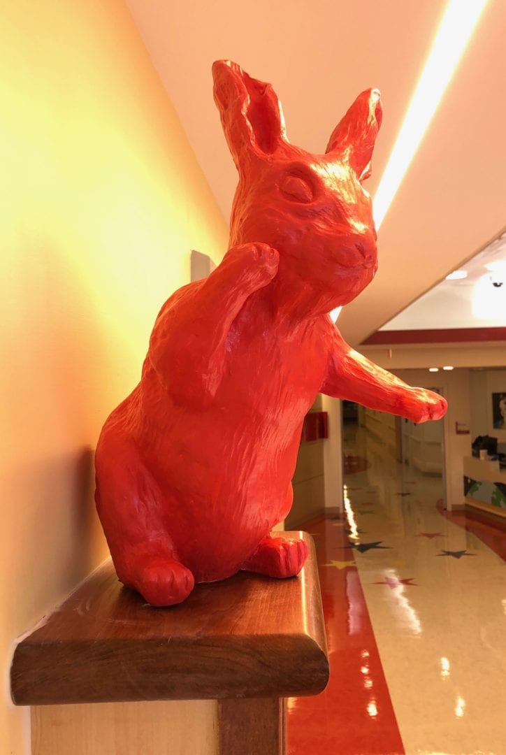 Another bunny by the elevator of Vanderbilt Children's Hospital 11th floor--pointing at the mural. All art by Rachael McCampbell © 2020